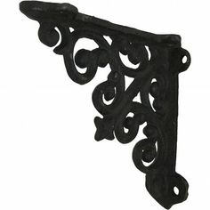 an ornate iron shelf bracket on a white background