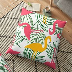 two flamingos and palm leaves on a white background floor pillow with pink, green, yellow