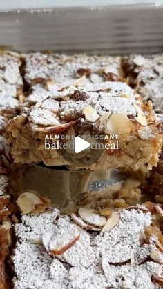 a close up of a tray of food with powdered sugar and nuts on top