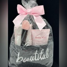 a bag filled with makeup products and a pink bow on the top of it's handle