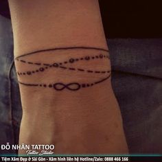 a person with a tattoo on their wrist that has an image of two circles in the middle