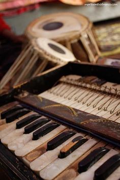 an old musical instrument sitting on top of a table next to other music instruments,