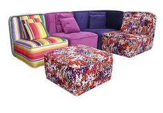 a multicolored couch and footstool sitting next to each other