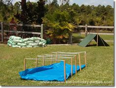 an inflatable trampoline is on the grass next to a play ground