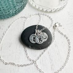 Sterling silver keepsake Initial necklace. Small circle charms are textured and stamped with the letters that mean the most to your heart. Add your initials in the order notes box at checkout. Solid sterling silver charms 1/4 wideSterling silver cable chain. Silver Stamped Initial Pendant Necklace, Hand Stamped Heart Sterling Silver Charm Necklace, Personalized Stamped Initial Pendant Charm Necklace, Silver Hand-stamped Initial Pendant Necklace, Elegant Sterling Silver Hand-stamped Initial Necklace, Light Grid, Silver Initial Charms, Sterling Silver Charms, Small Circle