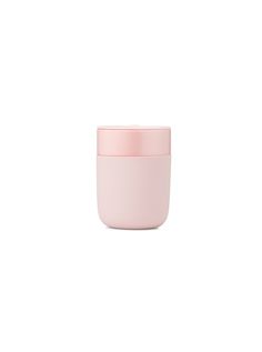 a pink cup sitting on top of a white table