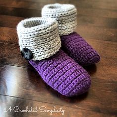 two crocheted slippers sitting on top of a wooden floor