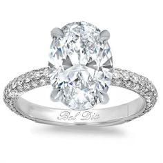 an oval cut diamond engagement ring with pave set shoulders