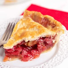 a piece of pie sitting on top of a white plate with a fork next to it