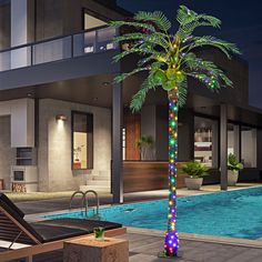 a palm tree decorated with multicolored lights next to a swimming pool