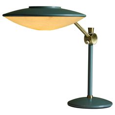 a green table lamp with a white background