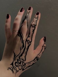 a woman's hand with black and white ink on it, showing the design