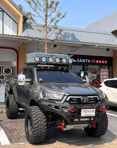 a black truck parked in front of a building