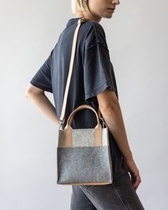 Small but mighty, the Jaunt Mini Merino Wool Tote is designed for both style and versatility. This compact tote holds essentials while adding character to any outfit and can be carried as a chic handheld or worn as a crossbody for hands-free ease. Perfect for quick errands or casual outings, it’s a refined yet functional piece for your everyday wardrobe.

  

 Benefits of Merino Wool 

  
 * Sustainable, biodegradable, and renewable 
 * Odor, stain, heat, and dirt-resistant 
 * Oeko-Tex® Certifi Leather Trim Crossbody Shoulder Bag For Work, Crossbody Shoulder Bag With Leather Trim For Work, Modern Shoulder Bag With Leather Trim For Fall, Modern Leather Trim Shoulder Bag For Fall, Modern Rectangular Bag Strap For Everyday Use, Modern Leather Bag Strap For Daily Use, Modern Crossbody Satchel For On-the-go, Modern Fall Shoulder Bag With Leather Handles, Modern On-the-go Crossbody Satchel