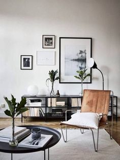 a living room filled with furniture and pictures on the wall