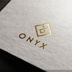 the logo for a company called onyx is shown in gold and silver letters, which appear to be interlocked