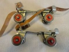 two red wheels are attached to a brown strap