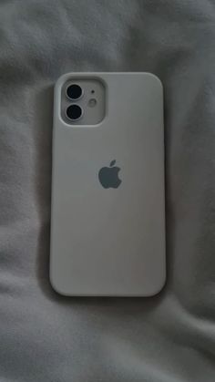 an iphone case sitting on top of a white bed sheet with the back cover open