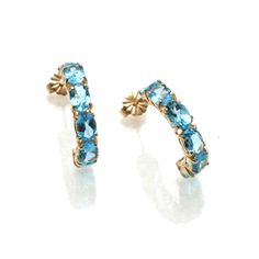 "This is a stunning pair of vintage earrings! These lovely earrings are made of 14k yellow gold. They are hoop earrings, each one set with 6 oval cut vibrant Swiss blue topaz stones. The total carat weight of the (12) stones is 6.03 carats. They are posts with nut backings. They are bright and comfortable to wear! The earrings measures approximately 7/8\" long by 1/4\" wide. They come in a pouch perfect for safekeeping or gift giving. Please check out my other items, I will combine shipping!" Elegant Blue 14k Gold Hoop Earrings, Classic Yellow Gold Hoop Earrings With Gemstone, Classic Gemstone Hoop Earrings For Anniversary, Classic Yellow Gold Blue Topaz Earrings, Classic Blue Topaz Yellow Gold Earrings, Classic Gold Earrings With Blue Topaz, Brass Picture Frames, Art Nouveau Antiques, 12 Stones