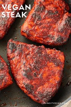 four pieces of meat cooking in a frying pan