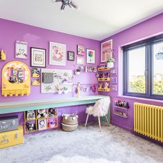 a room with purple walls and lots of pictures on the wall, including a yellow radiator