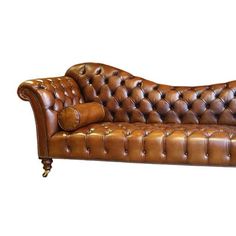 a brown leather couch sitting on top of a white floor