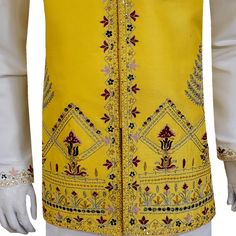 A handcrafted yellow designer waistcoat that elevates your look beyond compare. Crafted with meticulous attention to detail by skilled artisans, this waistcoat isn't just another import. It's a statement piece designed to turn heads at American mehndi celebrations. The vibrant yellow hue is a burst of festivity, while the premium quality fabric drapes effortlessly, ensuring a comfortable and sophisticated fit. Multicolor handwork adorns the waistcoat, each intricate detail a testament to the artistry behind this masterpiece. The exquisite craftsmanship is guaranteed to leave a lasting impression, making you the center of attention on your special day. Pair this stunning waistcoat with a classic white kurta pajama for a timeless mehndi ensemble that exudes sophistication. Customizable Perfe Fitted Yellow Kurta With Intricate Embroidery, Traditional Yellow Nehru Jacket For Festivals, Yellow Kurta With Intricate Embroidery For Festivals, Traditional Fitted Vest With Intricate Embroidery, Fitted Traditional Vest With Intricate Embroidery, Festive Fitted Vest With Intricate Embroidery, Yellow Kurta With Intricate Embroidery And Traditional Drape, Traditional Fitted Vest For Festive Occasions, Traditional Fitted Festive Vest