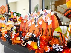 an assortment of candy and decorations on a mantle