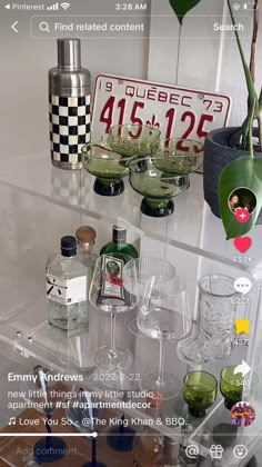 there are many glasses and bottles on the shelf next to each other, all in different shapes and sizes