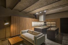 a living room filled with furniture next to a kitchen