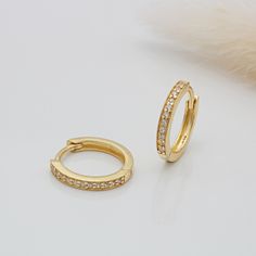 A timeless design these 18ct gold vermeil and cubic zirconia huggie hoops are perfect for all occasions. A wonderful gift or treat for yourself. They are complete with a secure click-in fastening for wearing day and night. Diameter: 13mm 925 Sterling Silver and 18ct Gold Vermeil, Cubic Zirconia Stones  Your item will come packaged in a lovely gift box for an added special touch. Unfortunately, we are unable to accept returns for this item due to hygiene reasons. Yellow Gold Channel Set Huggie Earrings As Gift, Classic Gold Huggie Earrings Channel Set, Cubic Zirconia Huggie Earrings With Brilliant Cut As Gift, Gold Huggie Earrings With Diamond Accents As A Gift, Classic Gold Channel Set Huggie Earrings, Brilliant Cut Cubic Zirconia Huggie Earrings As Gift, Gold Hoop Earrings Channel Set As Gift, Gold Huggie Earrings With Diamond Accents For Gifts, Gold Huggie Hoop Earrings With Brilliant Cut