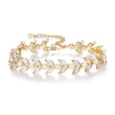 a gold bracelet with white pearls and leaves on the clasp, set against a white background