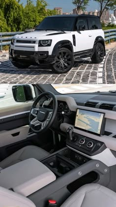 the interior and dashboard of a white land rover range rover parked on a cobblestone road