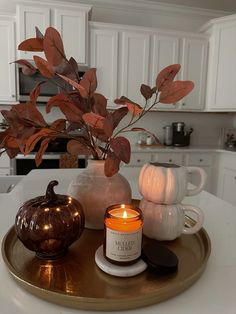 a candle is sitting on a tray in the kitchen