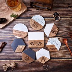 marble and wood coasters on a wooden table with pine cones, spoons and other items