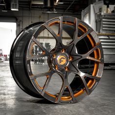 an orange and black wheel in a garage