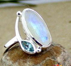 "Impressive Faceted moonstone ring, blue topaz ring, rainbow moonstone topaz jewelry,healing stone,Anniversary gift  ring,Modern Stylish designer ring,925 silver jewelry,Sterling silver ring,Superb handmade jewelry. MR1010 SKU - R28017  MR1010 Style - Cocktail Gemstone - Rainbow Moonstone, Blue Topaz Metal - 92.5 % Solid Sterling Silver Weight- 4.6 gm approx Ring Size - All sizes  Stone Size- 8x16, 3x6 mm  Stone Shape - Oval, Marquise Stone Cut - Faceted Healing Properties  Moonstone - Rainbow M Raw Gemstone Jewelry, Ring Moonstone, Rainbow Rings, Topaz Jewelry, Contemporary Ring, Diamond Jewelry Designs, Proposal Ring, 925 Silver Jewelry, Moonstone Ring