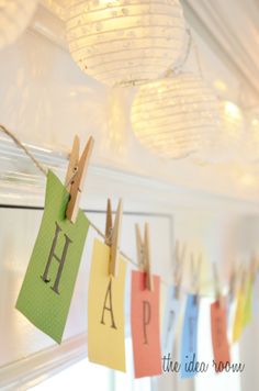 clothes pins are hung on the clothes line with letters that spell happy hanging from them