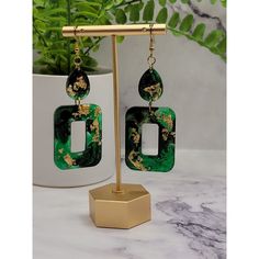 These Green Square drop earrings are a stylish and trendy addition to any jewelry collection. They feature resin dangle drops that are both lightweight and durable. The earrings are made with high-quality stainless steel, ensuring they are hypoallergenic and resistant to tarnish or rust. These earrings are designed for women and make for a perfect gift for any occasion. Whether it's for a birthday, anniversary, or simply to show appreciation, these earrings are sure to impress. They are a great Elegant Dangle Resin Earrings, Elegant Resin Dangle Earrings, Trendy Resin Drop Earrings, Elegant Green Resin Earrings, Green Resin Drop Earrings, Pierced Dangle Resin Earrings, Pierced Dangle Earrings In Resin, Single Dangle Resin Earring, Hypoallergenic Resin Dangle Earrings