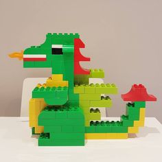 a lego model of a green, yellow and red alligator