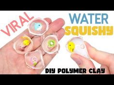 a person holding four small plastic objects in their hands with the words virtual water squishy on them