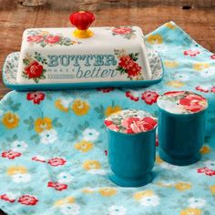 the table is covered with blue dishes and flowers