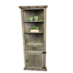 an old wooden bookcase with plants on top and two potted succulents in the bottom