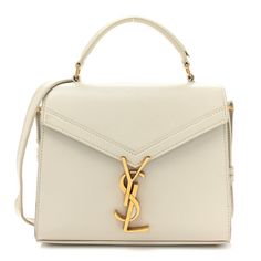 This is an authentic SAINT LAURENT Grain de Poudre Mini Classic Monogram Cassandra Top Handle in Crema Soft. This chic shoulder bag is crafted of pebble grain white calfskin leather. The bag features a rear patch pocket, gusseted side panels, a sturdy leather top handle, and an optional, adjustable shoulder strap with aged gold hardware. The envelope-style crossover flap opens with a matching gold YSL monogram press lock to a partitioned black leather interior with a patch pocket. Pop Stitch, Mini Classic, Classic Monogram, Purse Brands, Envelope Bag, Saint Laurent Bag, Wallet Chain, Black Cross Body Bag, Side Panels