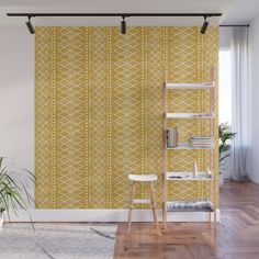 a yellow and white wallpaper with geometric design in the middle, on a wooden floor