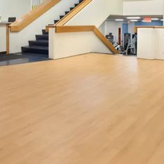 an empty dance floor with stairs in the background