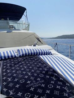 a blue and white blanket sitting on top of a boat