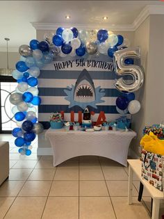 a shark themed birthday party with balloons and decorations