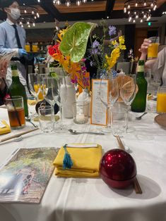 the table is set with wine glasses, menus and other items for an event