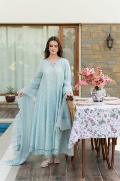 An alluring three piece, intricately designed on pure ice blue raw silk 60 gms, in a long kalidaar silhoutte, with cutwork cuffs and silver hand/ada craftsmenship done by our expert artisans. Styled with a pretty lacey pure organza dupatta and matching pencil trousers. The length of the flowy Kalidaar is 50 inches. Ord Eid Post, Blue Frock, Floral Prints Fashion, Pencil Trousers, Latest Maxi Dresses, Shadi Dresses, Latest Dress Design, Pakistani Fancy Dresses, Beautiful Pakistani Dresses